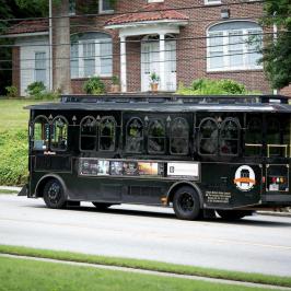 a truck driving down a street next to a bus