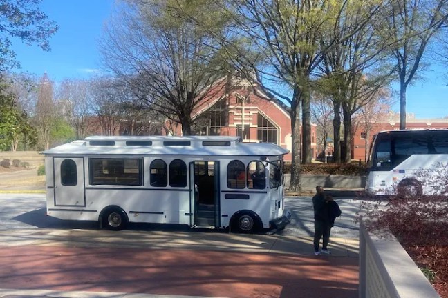 a passenger bus that is parked on the side of a road