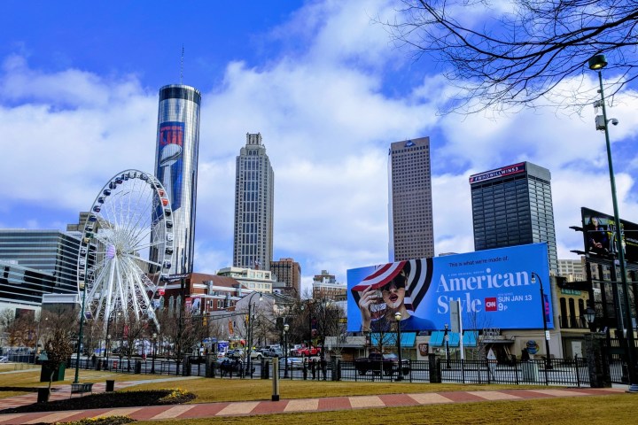 a group of people flying kites in a city