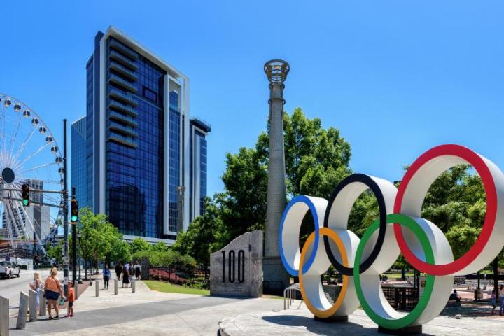 a group of people flying kites in front of a building