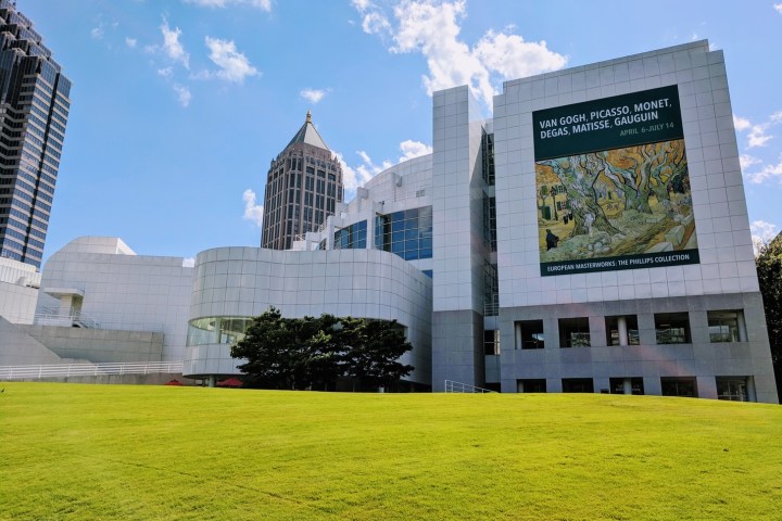 a large building with a grassy field
