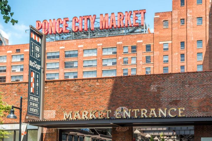 a building that has a sign on the side of a road