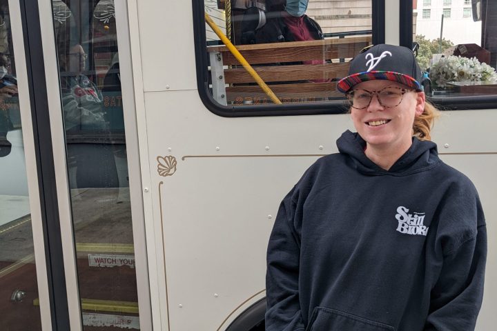 a man standing in front of a bus