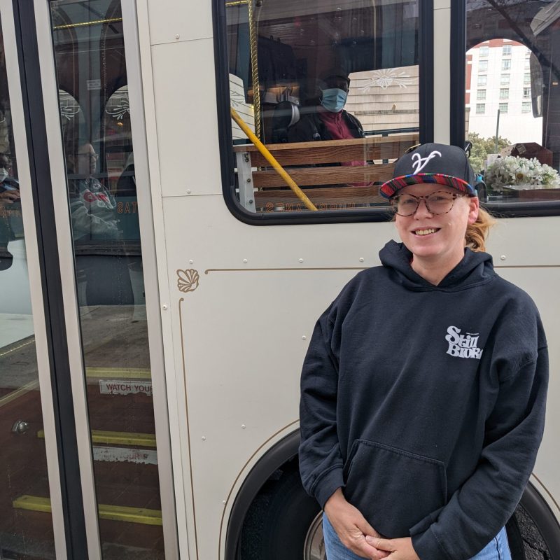 a man standing in front of a bus