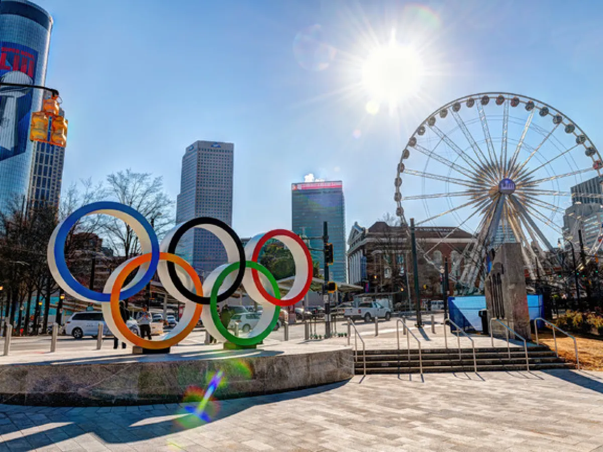 a group of people flying kites on a beach
