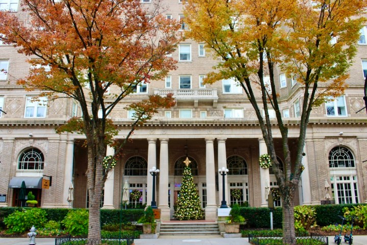 a large stone statue in front of a house