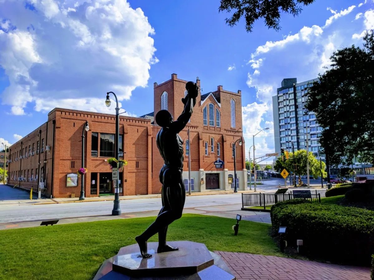 a large brick building with grass and trees