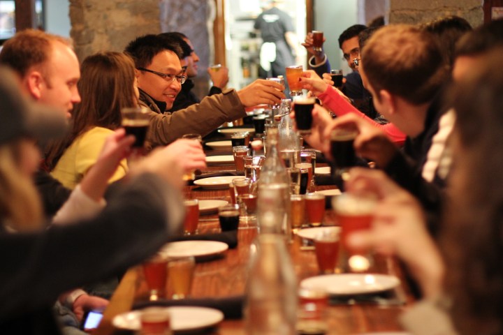 a group of people sitting at a table with wine glasses
