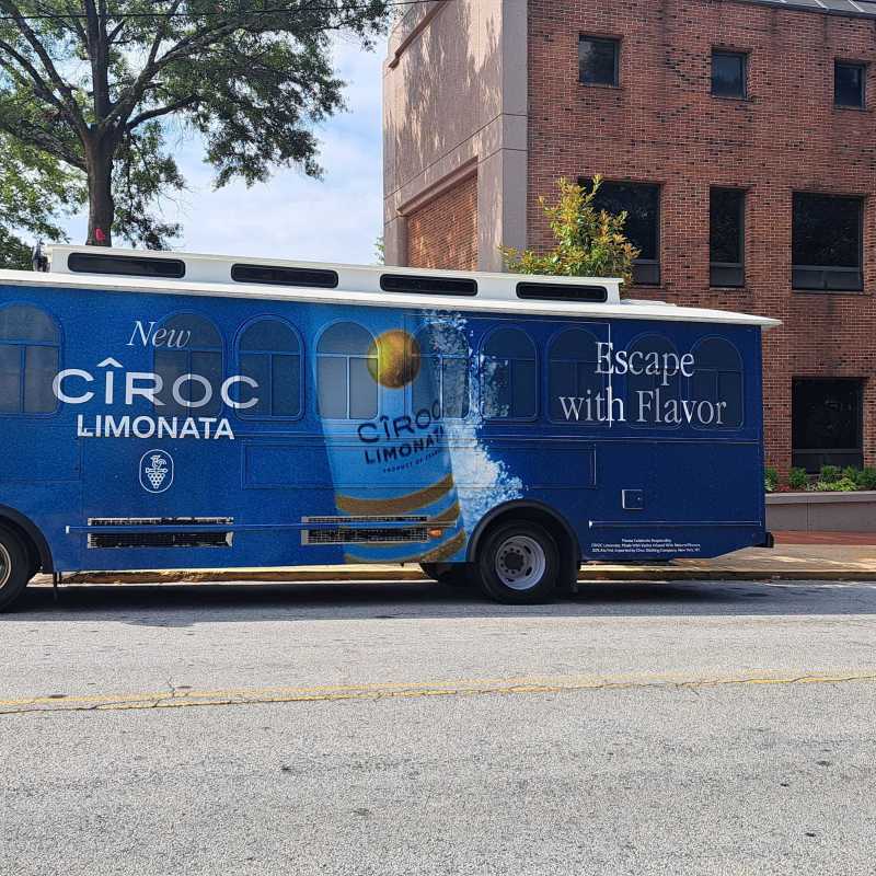 Blue promotional bus with 'Ciroc Limonata' parked on the street.